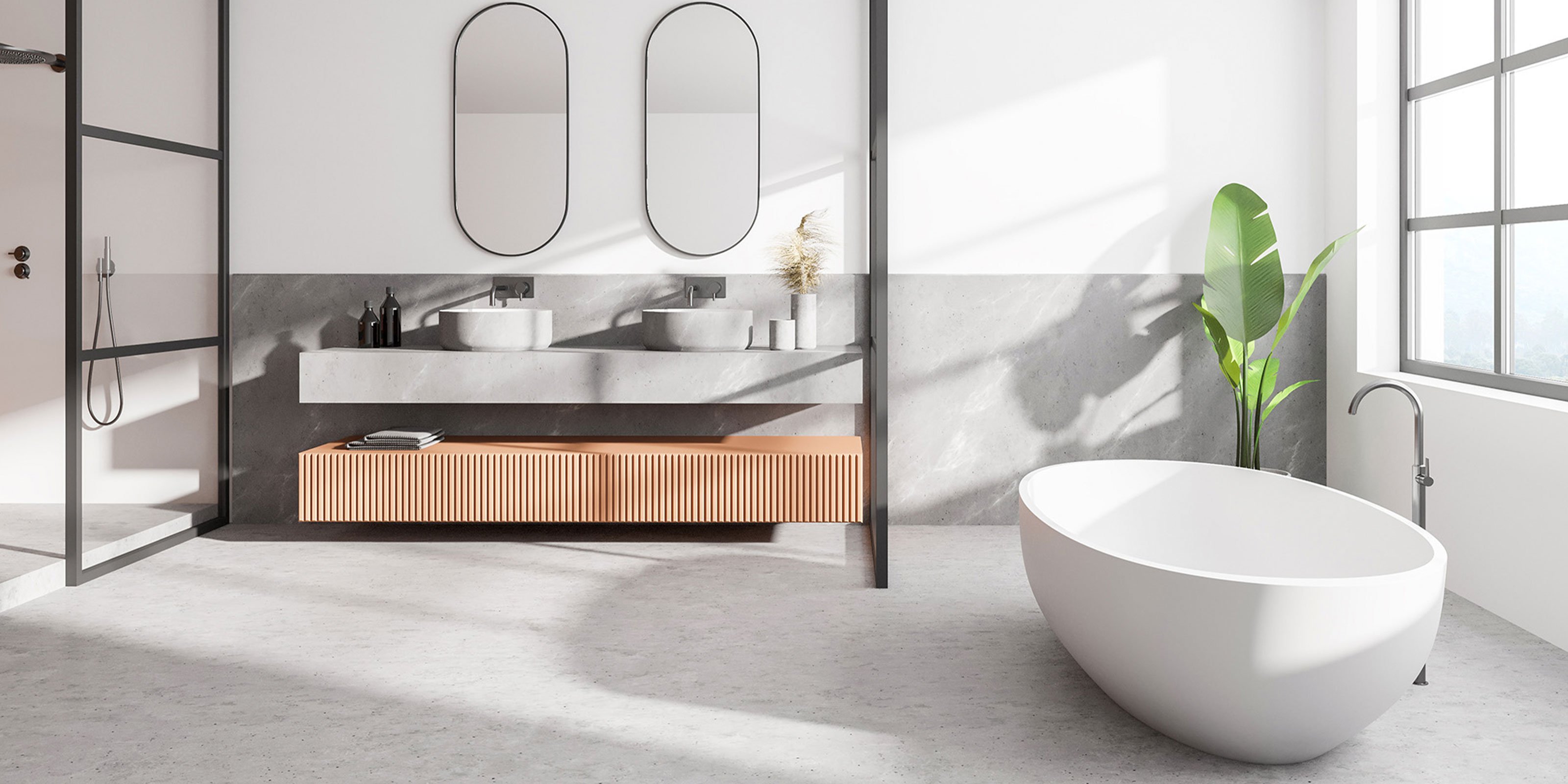 Ein modernes Badezimmer mit einer freistehenden Badewanne und eleganten Waschbecken auf einer grauen Arbeitsplatte.